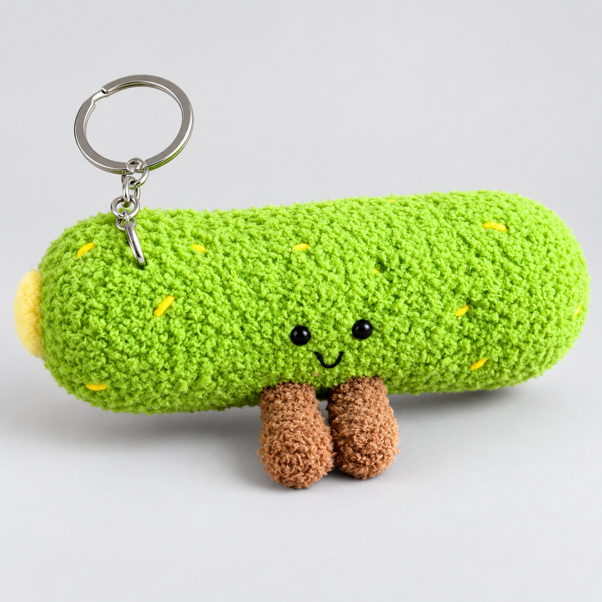 Cute Green Pickle Plush Keychain – Fuzzy Kawaii Bag Charm with Smiling Face and Dangling Legs